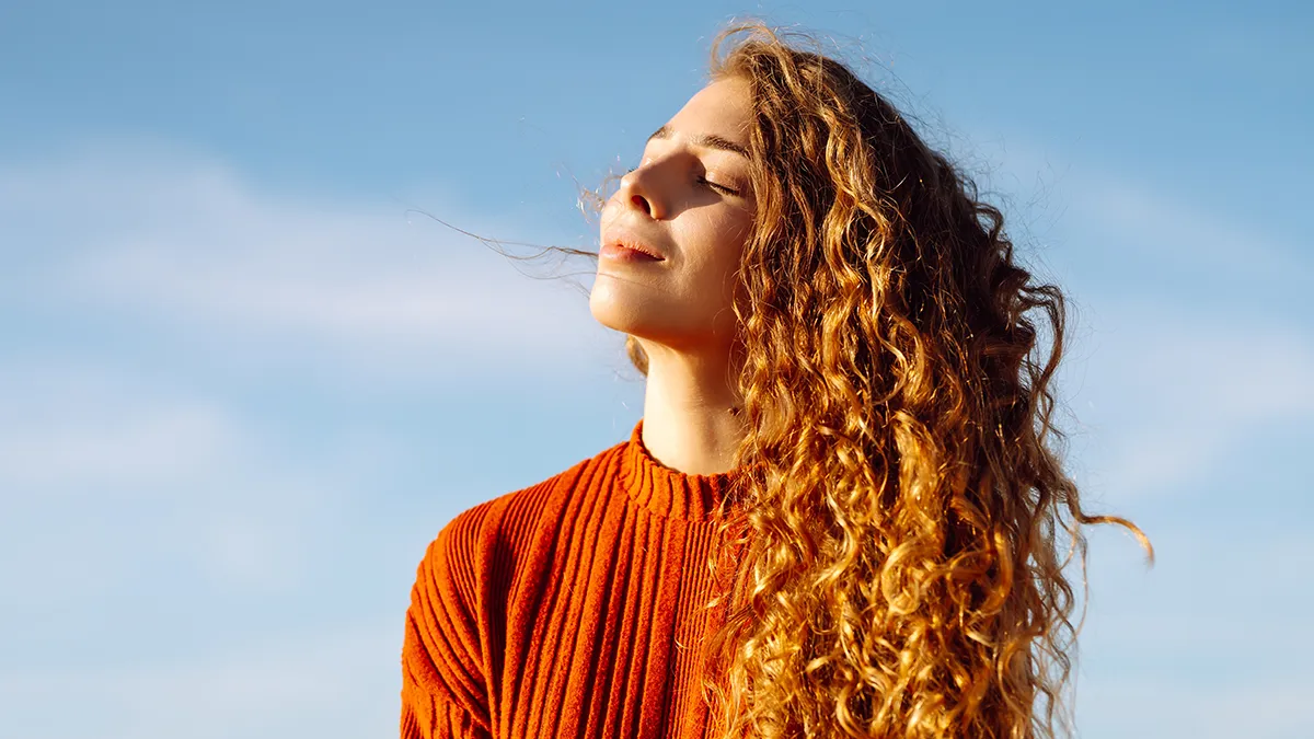 a woman with beautiful long ginger curly hair